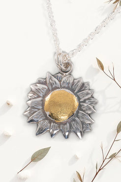 Sunflower-shaped pendant necklace with gold center on a white background